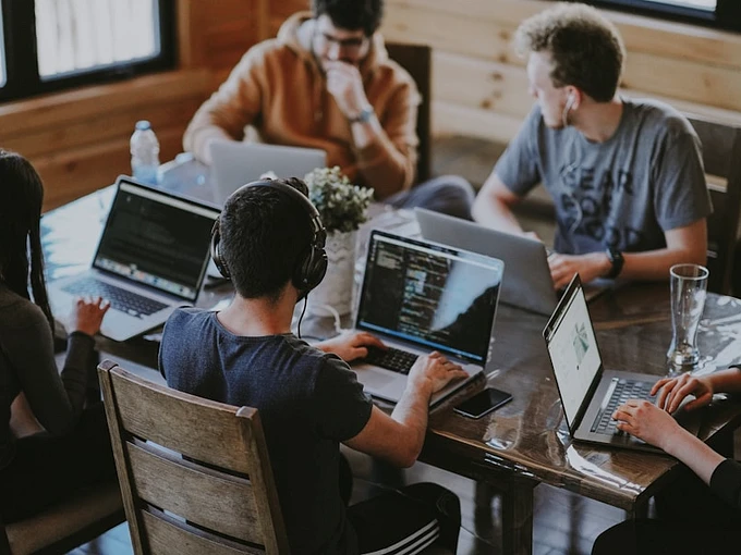 Executive hiring team reviewing candidate portfolios together in modern office