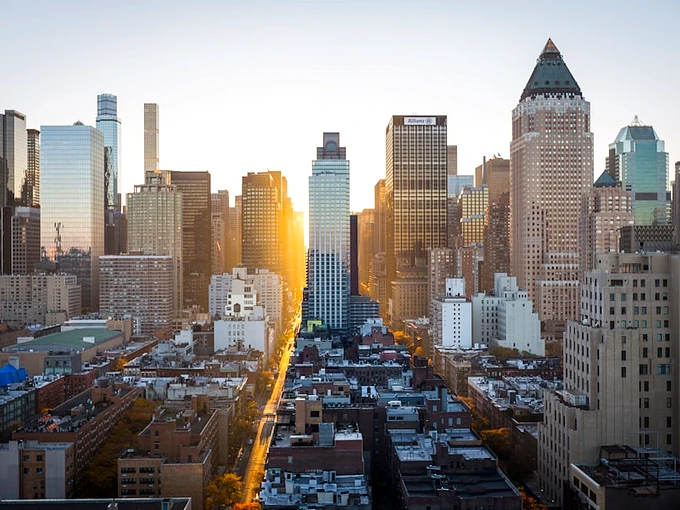 Golden hour sunset over modern city representing global candidate intake